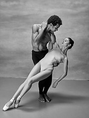 Image showing Couple of ballet dancers posing over gray background