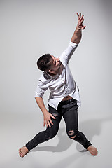 Image showing The young man dancing on gray