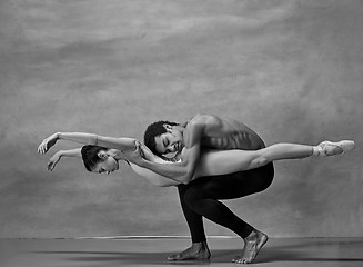 Image showing Couple of ballet dancers posing over gray background