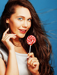 Image showing young pretty adorable woman with candy close up like doll