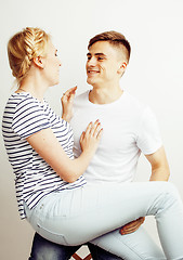 Image showing young pretty teenage couple, hipster guy with his girlfriend happy smiling and hugging isolated on white background, lifestyle people concept