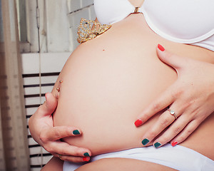 Image showing pretty belly of pregnant woman with tiars crown on it, lifestyle people concept