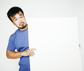 Image showing pretty cool asian man holding empty white plate smiling