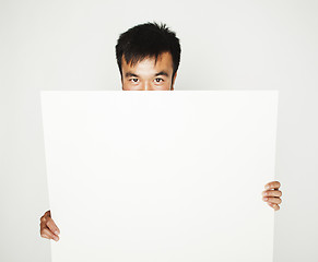 Image showing pretty cool asian man holding empty white plate smiling