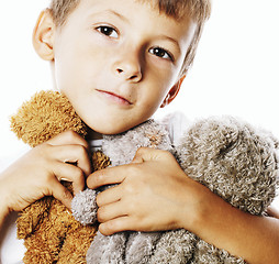 Image showing little cute boy with many teddy bears hugging isolated close up