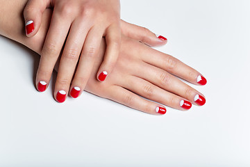 Image showing Female hands with red and white nails