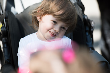 Image showing baby girl sitting in the pram