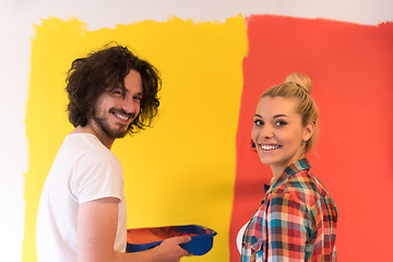 Image showing couple painting interior wall