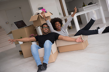 Image showing African American couple  playing with packing material