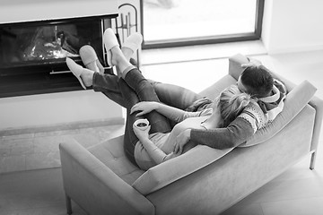 Image showing Young couple  in front of fireplace