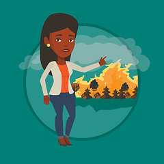 Image showing Woman standing on background of wildfire.