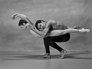 Image showing Couple of ballet dancers posing over gray background