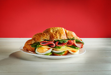 Image showing Croissants sandwiches on the wooden cutting board