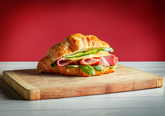 Image showing Croissants sandwiches on the wooden cutting board