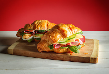 Image showing Croissants sandwiches on the wooden cutting board