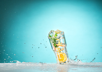 Image showing The rose exotic cocktail and fruit on blue