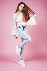 Image showing young pretty red hair ginger girl jumping isolated on pink background, lifestyle flying teen people happy smiling concept 