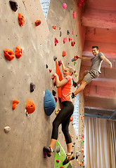 Image showing man and woman exercising at indoor climbing gym