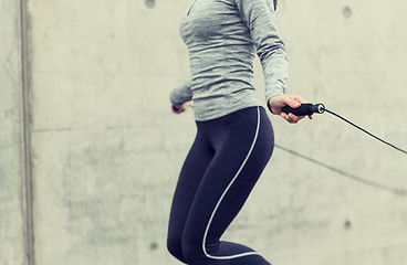 Image showing close up of woman exercising with jump-rope