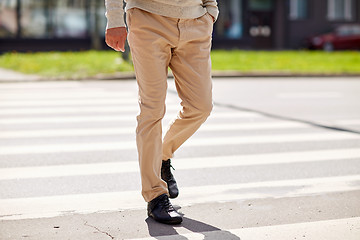 Image showing senior man walking along city crosswalk