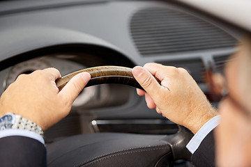 Image showing senior businessman hands driving car