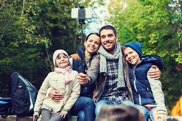 Image showing family with smartphone taking selfie near campfire