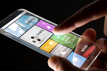 Image showing close up of hand with apps on smartphone