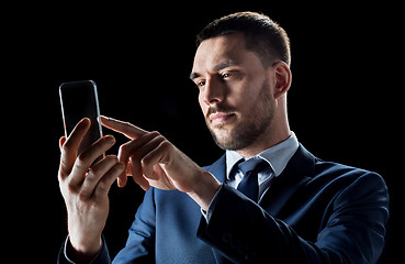 Image showing businessman with transparent smartphone