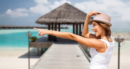 Image showing happy young woman in hat on summer beach