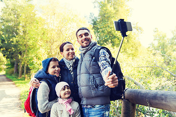 Image showing family with backpacks taking selfie and hiking