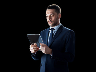 Image showing businessman in suit with transparent tablet pc