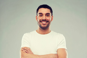 Image showing smiling man with crossed arms over gray background