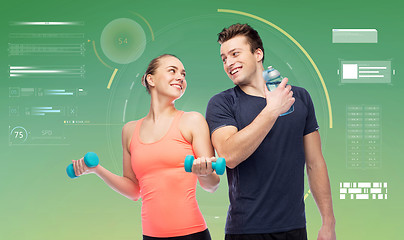 Image showing sportive man and woman with dumbbells and water