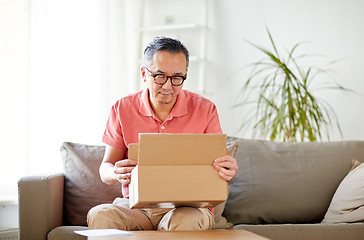 Image showing man opening parcel box at home