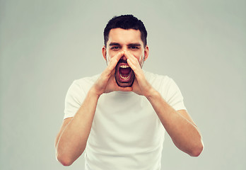 Image showing angry shouting man in t-shirt over gray background