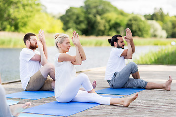 Image showing people making yoga and meditating outdoors