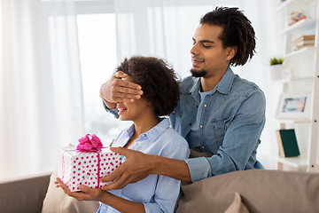 Image showing happy couple with gift box at home