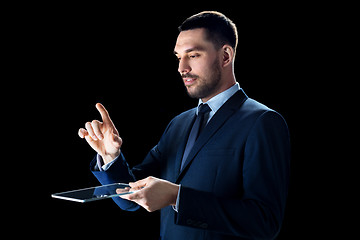 Image showing businessman in suit with transparent tablet pc