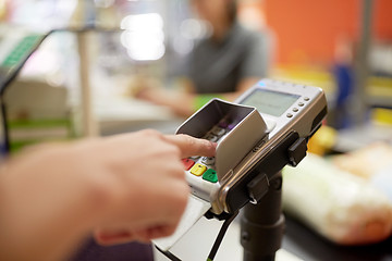 Image showing woman entering pin code at store cash register