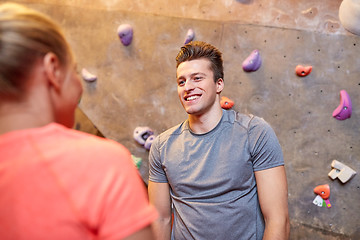 Image showing man and woman talking at indoor climbing gym wall