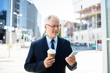 Image showing businessman with smartphone and coffee in city