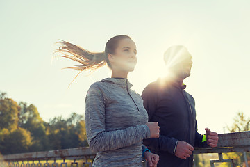 Image showing happy couple running outdoors