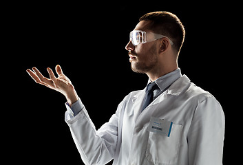 Image showing doctor or scientist in lab coat and safety glasses