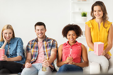 Image showing happy friends with popcorn watching tv at home