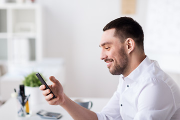 Image showing businessman with smartphone at office