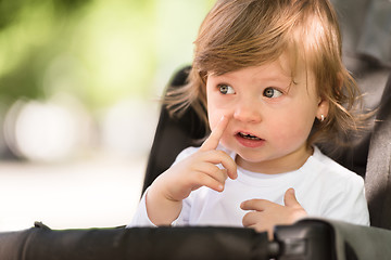 Image showing baby girl sitting in the pram