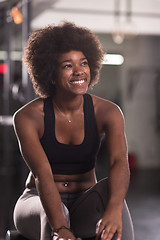 Image showing black woman doing sit ups at the gym