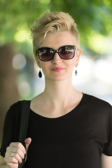 Image showing young woman with short blond hair and sunglasses