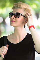 Image showing young woman with short blond hair and sunglasses