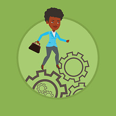 Image showing Business woman running on cogwheels.